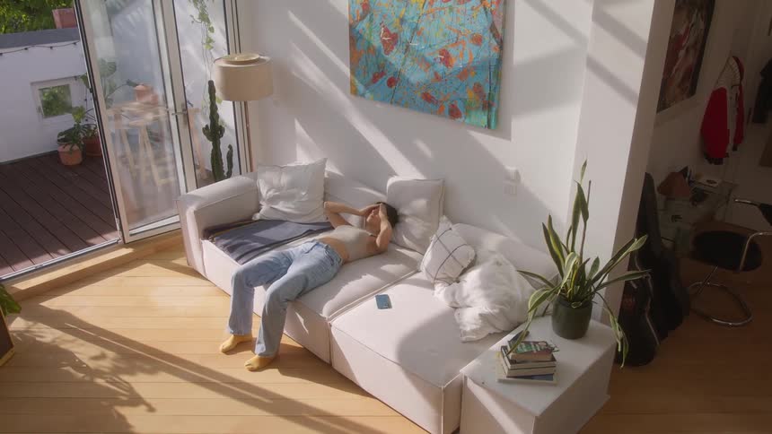 Woman lying on an couch in the living room