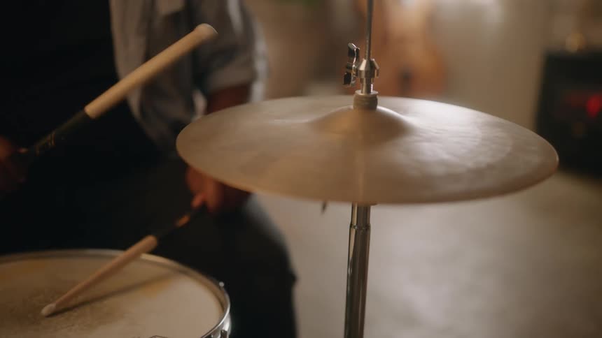 A man is playing the drums in the studio