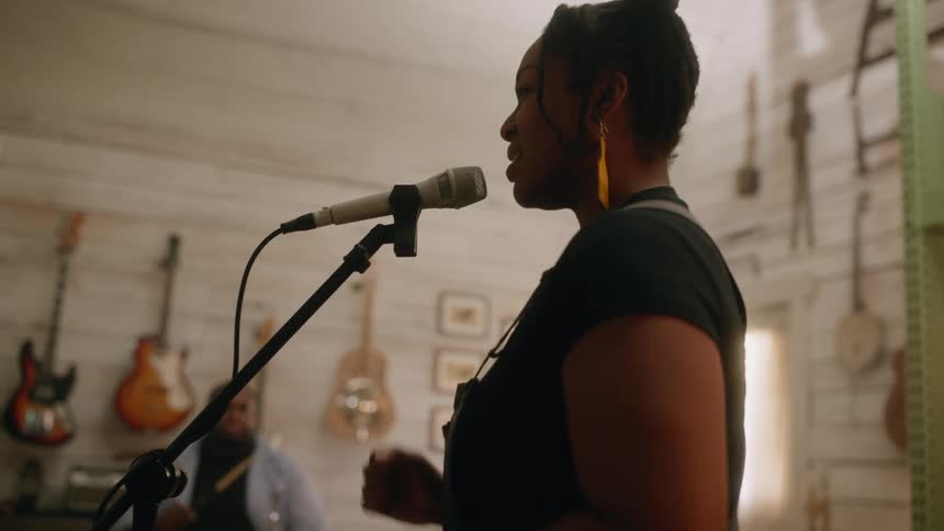 Footage of a band playing while the vocalist sings