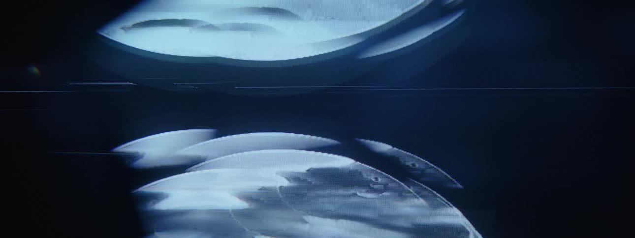 A circular image of rippling water scrolls upwards on a screen