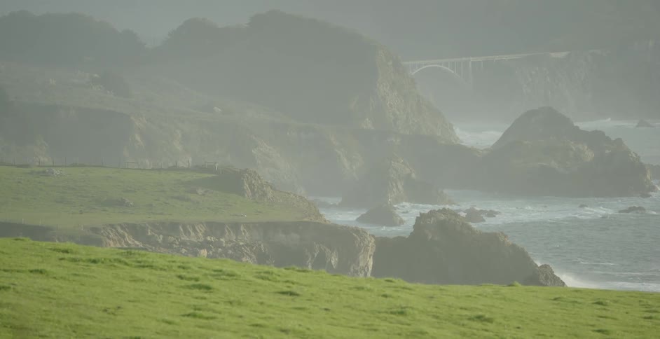 The cliff area around this shore is covered with fog and grass
