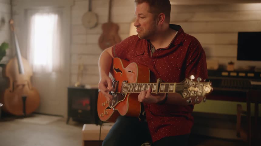 A man has fun playing an electric guitar