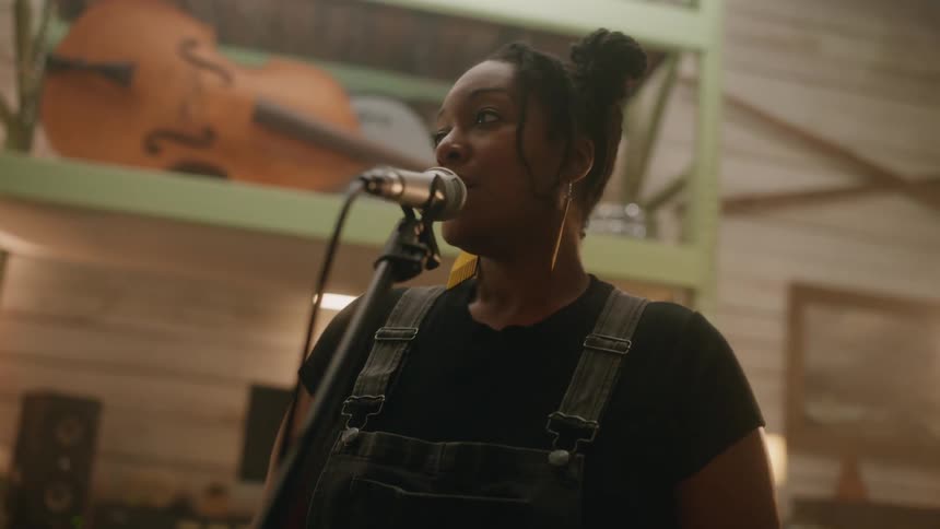 A woman is singing into the microphone