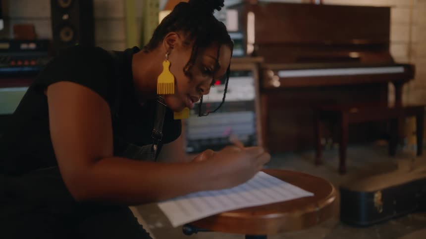 A woman is writing sheet music