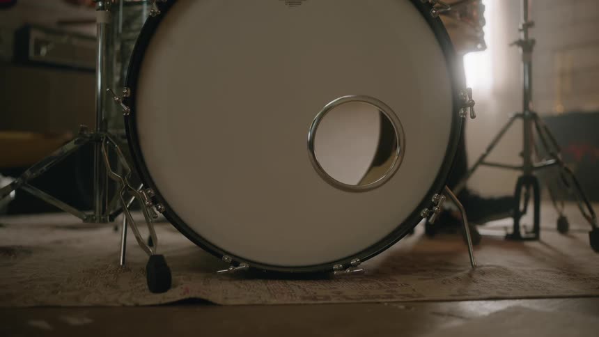 A drummer taps his foot on a pedal