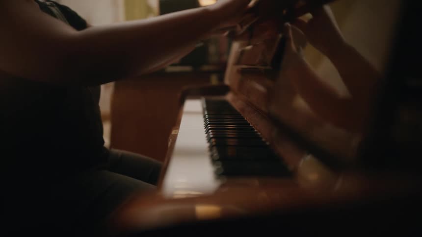 Womans hands closing a piano after playing