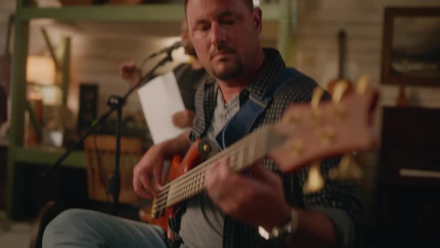 A clip of a man playing a bass guitar