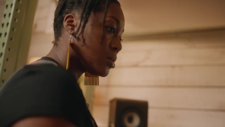 A woman talks to someone next to her and is nodding her head in confirmation