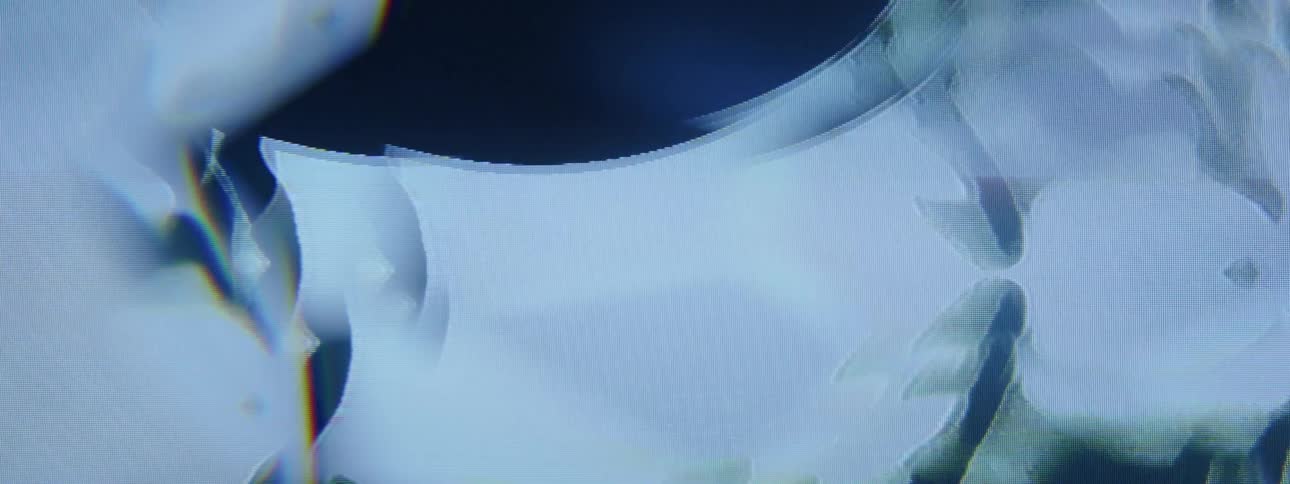 Dark oval slowly rises on background of black and white shifting patterns