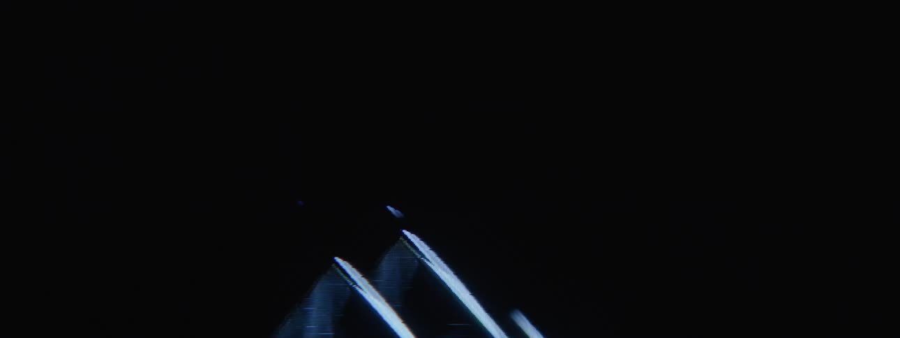 A reflective triangle rises in the artwork