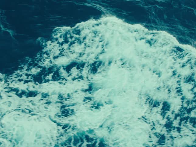 The surface of the sea with some movements forming white foam