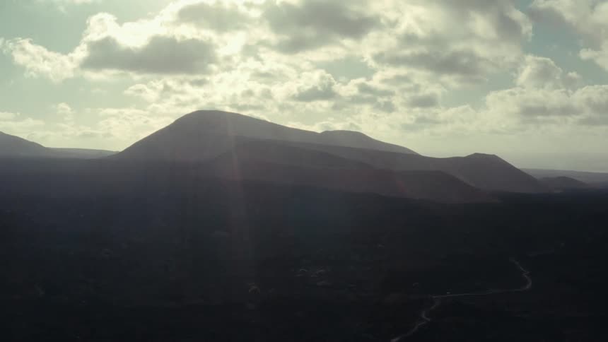 Aerial panorama of a mountain valley with morning solar reflections