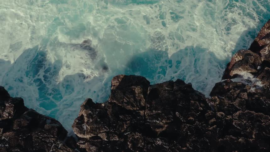 Foamy waves crashing on rocks