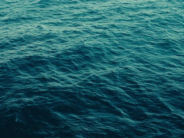 The blue waters of the ocean are rough