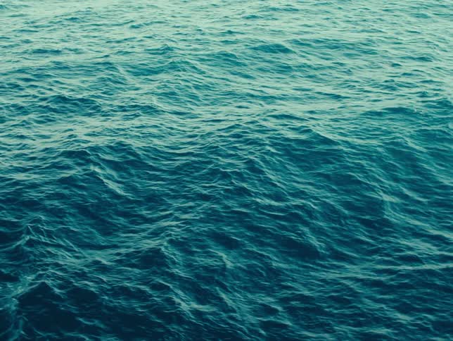 Aerial view of water with ripples and waves