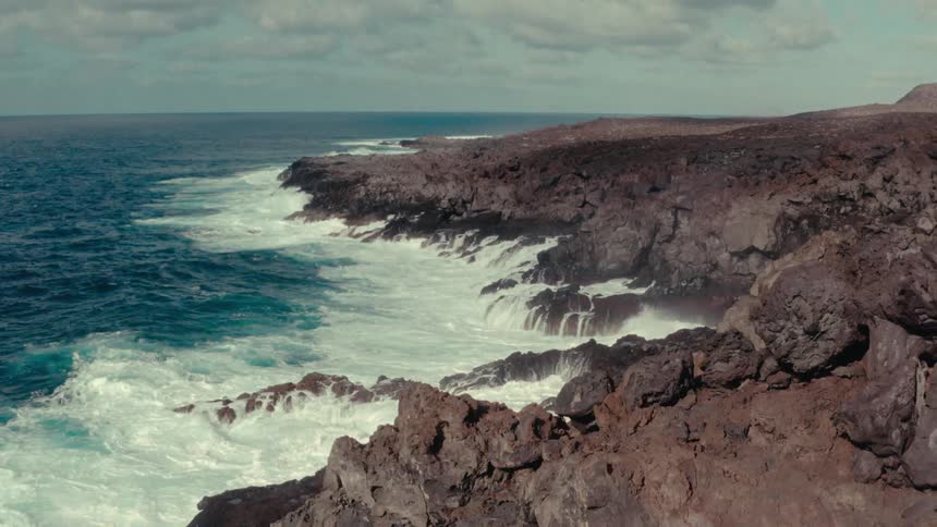 Landscape of the rocky coast at the edge of a blue ocean