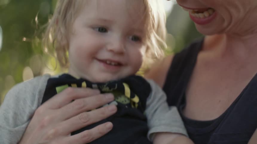 Woman holding and smiling with a toddler