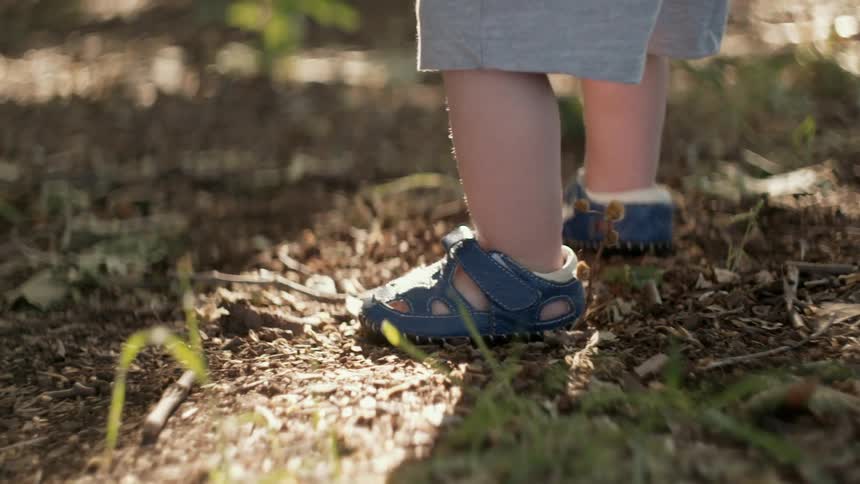 Toddler taking shaky steps outside