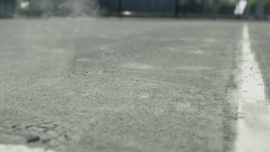 A tennis ball gives off dust as it bounces on the court