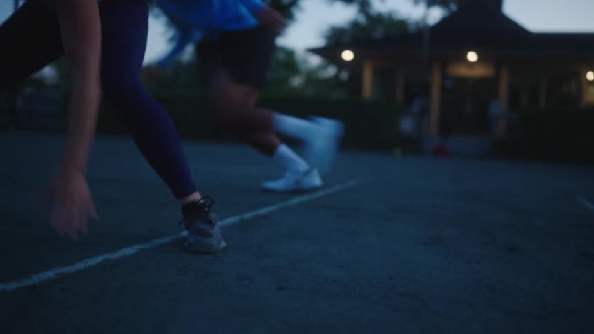 Two tennis players run sprints together on a court
