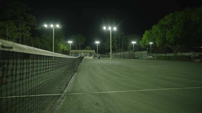 Lights on tennis courts lighting up at night