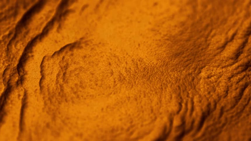 An orange textured surface smoking and moving