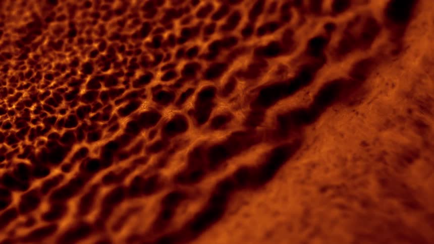 An orange substance flowing and compacting