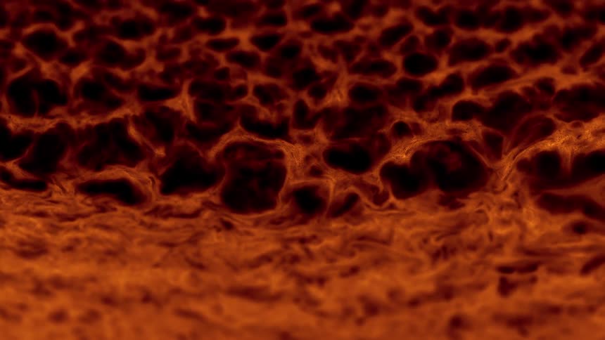 Extreme closeup on a dense brown liquid bubbling