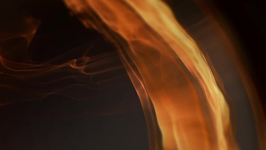 An arch of a flowing orange and yellow flaming waves against a dark background