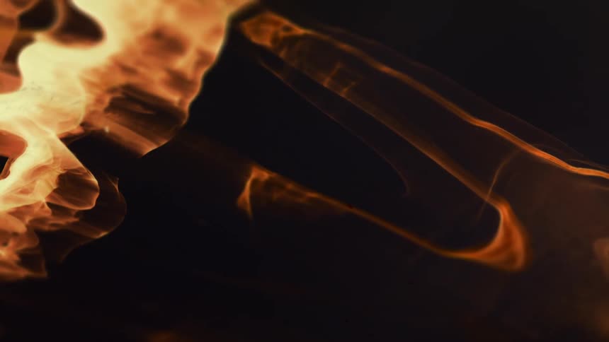 Flames move like liquid in a dark medium