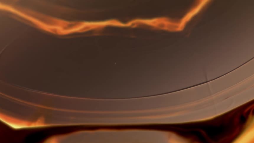 Orange and brown liquids flow and expand