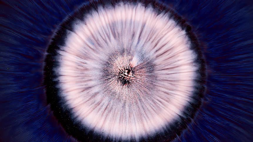 Abstract glowing liquid expanding through the core