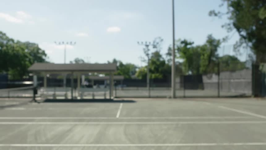 Racket hitting a tennis ball on an open court