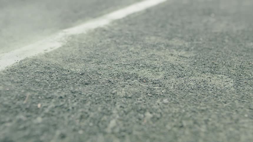 A tennis ball hitting the ground on a court