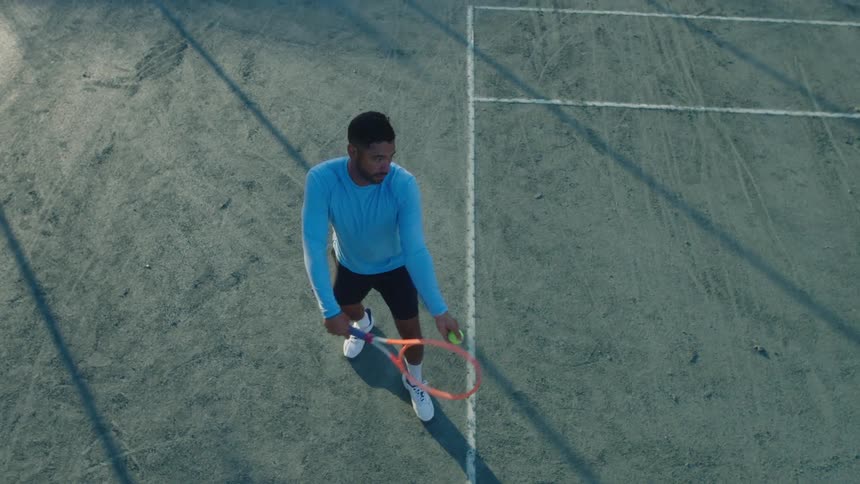 A tennis player hits a serve on a court