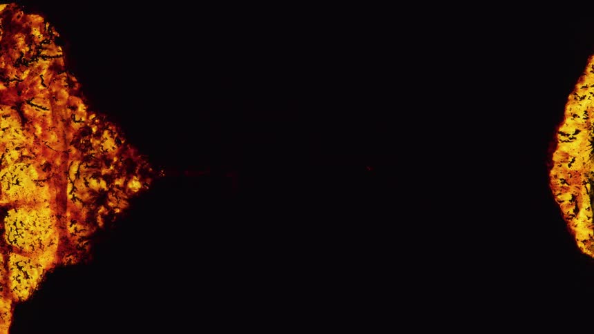 A black color darkening an orange lava surface and then there is a circular expansion