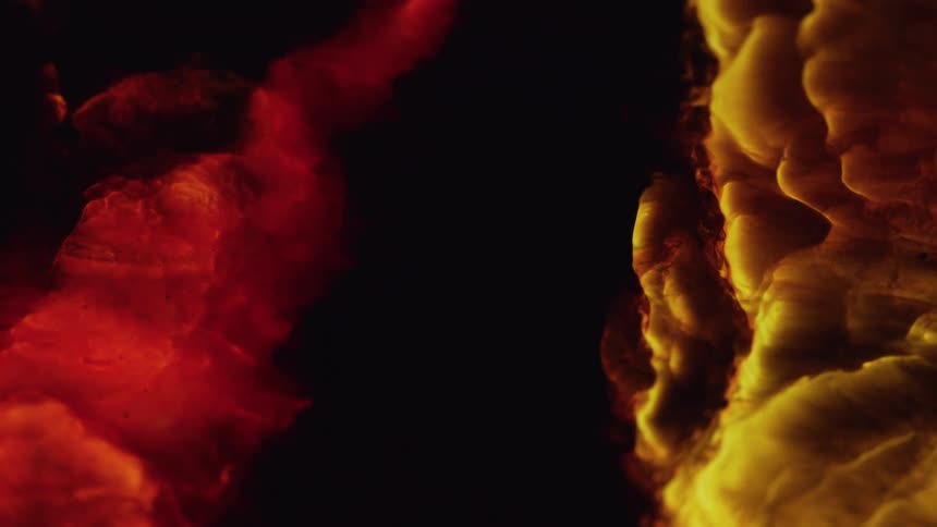 Vibrant red and yellow colored waves pushing each other without mixing