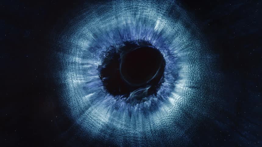 A circular shape of blue particles on a black background