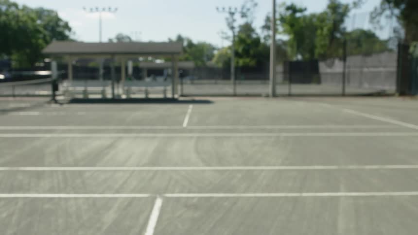 Racket hitting a tennis ball on a court