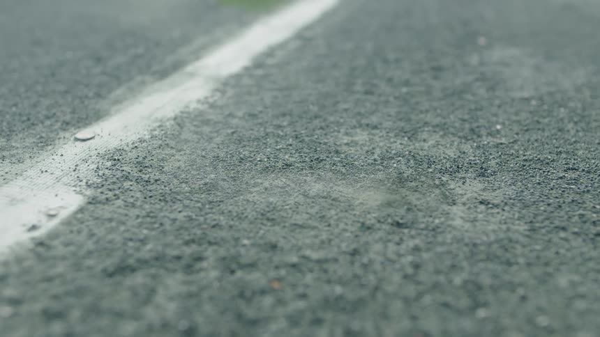 Tennis ball touching the ground on a court during the day