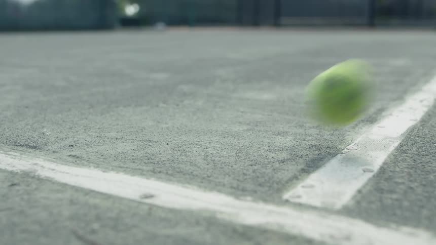 Tennis ball bouncing on a court