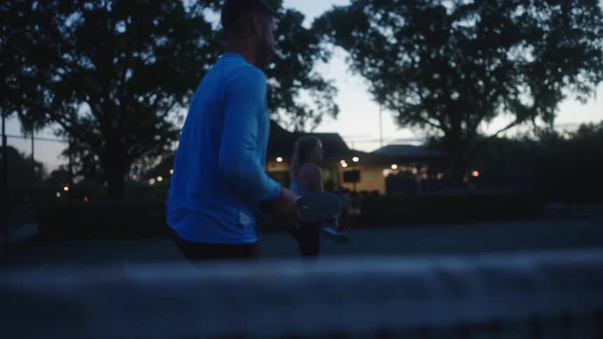 Tennis players doing stretching exercises on a court