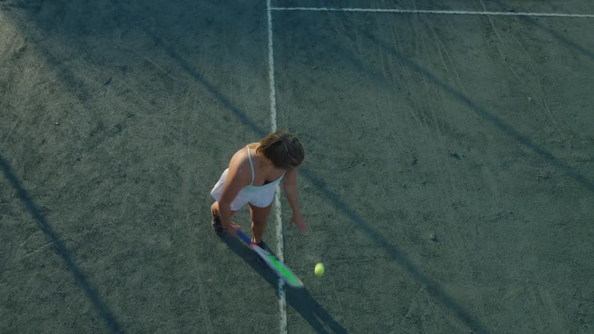 Woman making a serve with a racket in a tennis match