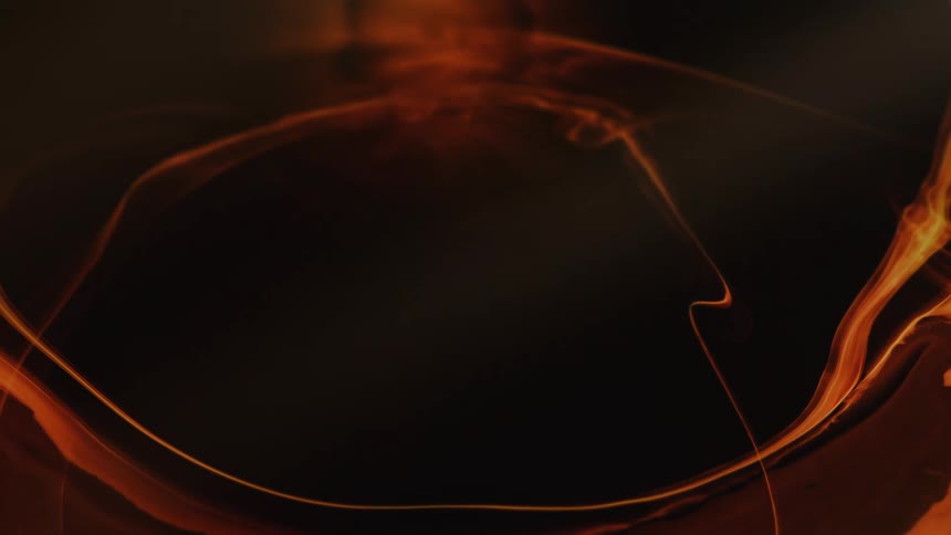 Warm colored dense liquid expanding in abstract shape