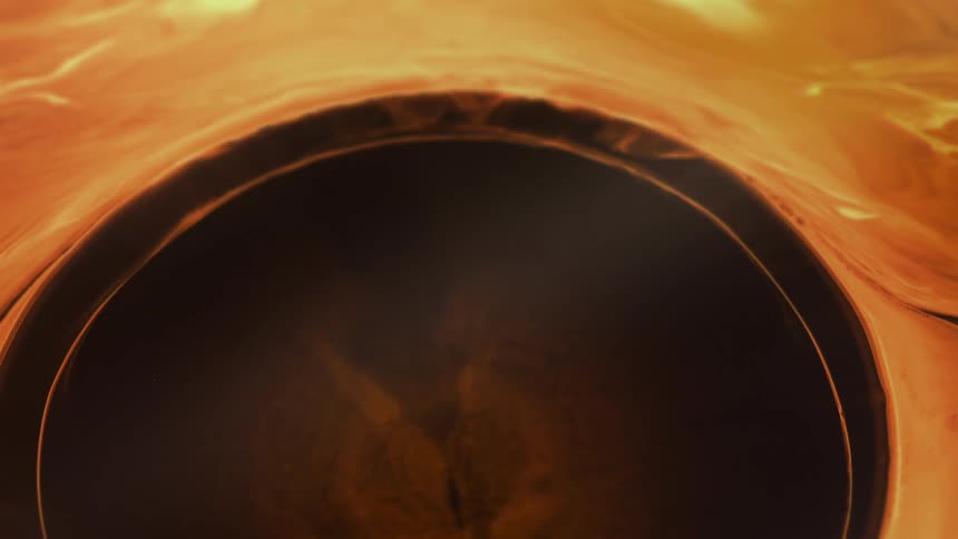 Bubble expanding into a dense reddish liquid of abstract texture