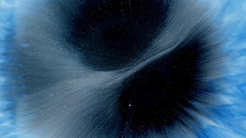 A circular explosion of blue particles on a completely black background