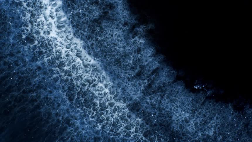 Closeup view of dark blue liquid with abstract patterns