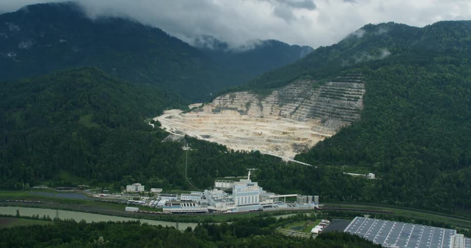 An aerial view of a hole in a mountain left by mining
