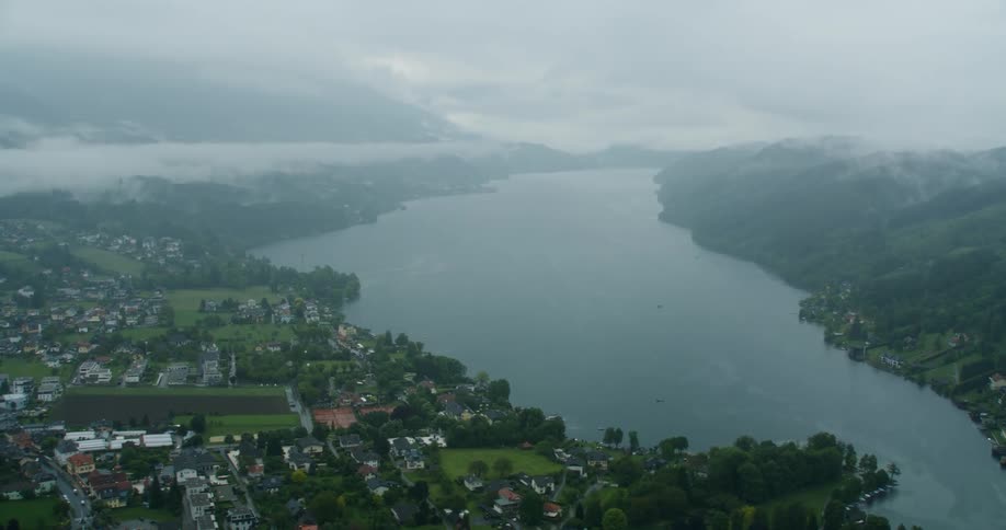 Aerial aerial panorama of a residential town by a lake and mountains