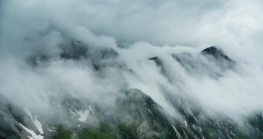 A mountain peak covered by fog